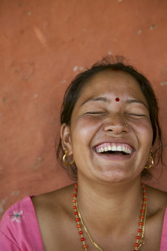 Happy young Nepali woman who cant control her laughter.