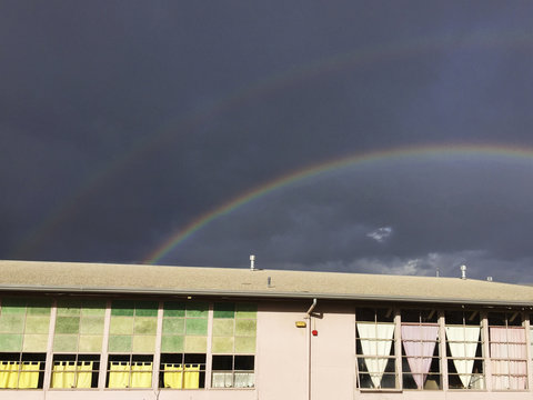 double rainbow over an old school