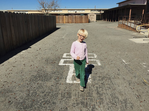 happy child playing hopscotch