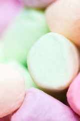 Colorful mini marshmallows background macro. Fluffy marshmallows texture and pattern. Flat lay or top view. Winter food background concept.