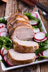 Roast pork fillet with with arugula and radish salad