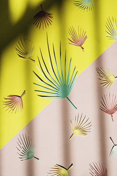 Palm leaf pattern on a pink and yellow diagonal background with shadow