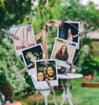  A picture print on a heart shaped hanger in a garden