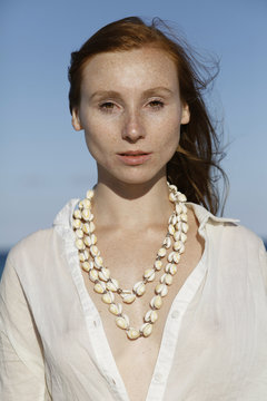 portrait of young woman  with shells-necklace