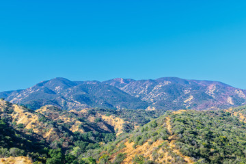 Red fire retardant hills in the backgroun
