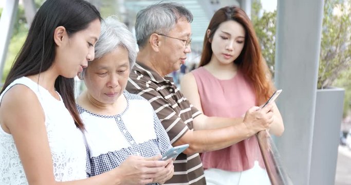 Family using mobile phone together