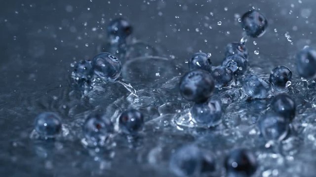  Slowmo fresh blueberries falling & splashing into clean fresh water