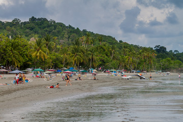 Fototapeta na wymiar MANUEL ANTONIO, COSTA RICA - MAY 13, 2016: People on a beach in Manuel Antonio village, Costa Rica