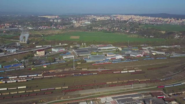 Flight over railway depot. Aerial view of cargo trains. Industrial zone with railway in the city.
