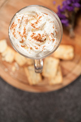 cream in a glass, sprinkle with cinnamon, top view