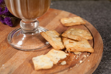 snacks are on a wooden tray as a snack with a cup