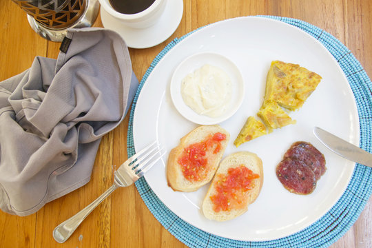 Spanish potato tortilla, bread and sauce served on the plate