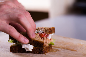 Cooking fresh homemade grilled tuna sandwich on wood