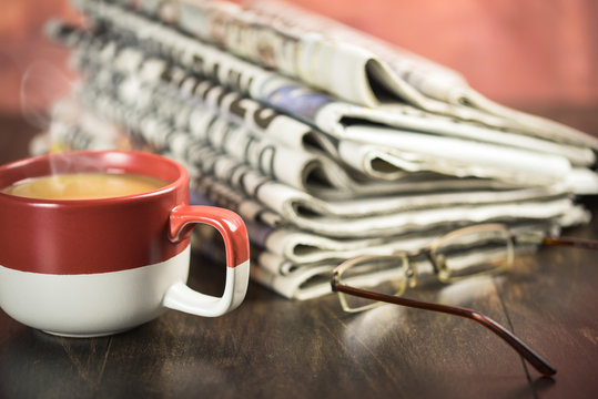 Newspaper with a cup of coffee