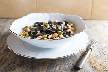 Black ink pasta with chicken and green olives