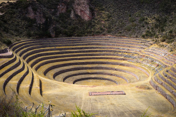 Fototapeta na wymiar The archaeological site at Moray, travel destination in Cusco region and the Sacred Valley, Peru. Majestic concentric terraces, supposed Inca's food farming laboratory.