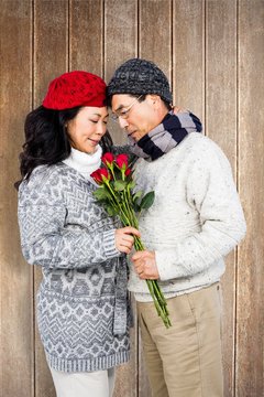 Composite Image Of Older Asian Man Giving His Wife Flowers