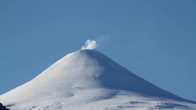 Smoke over the snow covered Villrrica Volcan, Chile