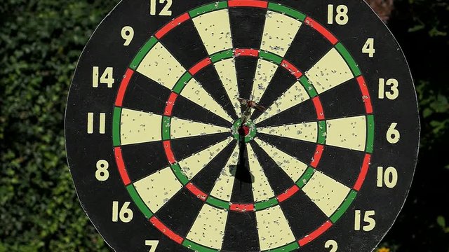 Slow Motion Dart Hitting The Bulls Eye Hanging Board