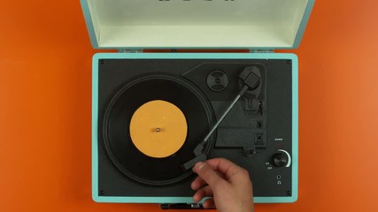  Overhead view hands closing lid on colorful vintage record player, slow motio