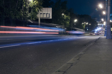 Automobile traffic on a city street at night