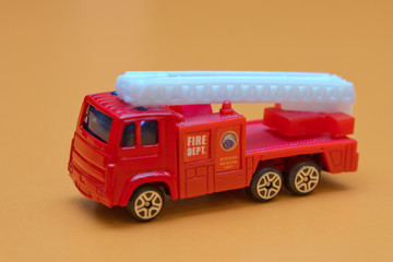 Red toy fire truck / Very fast to rescue children safe from fire.
