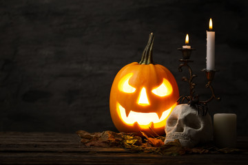 Scary halloween pumpkin with skull in a spooky night. Halloween scene.