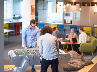 Office People Enjoying Table Soccer Game