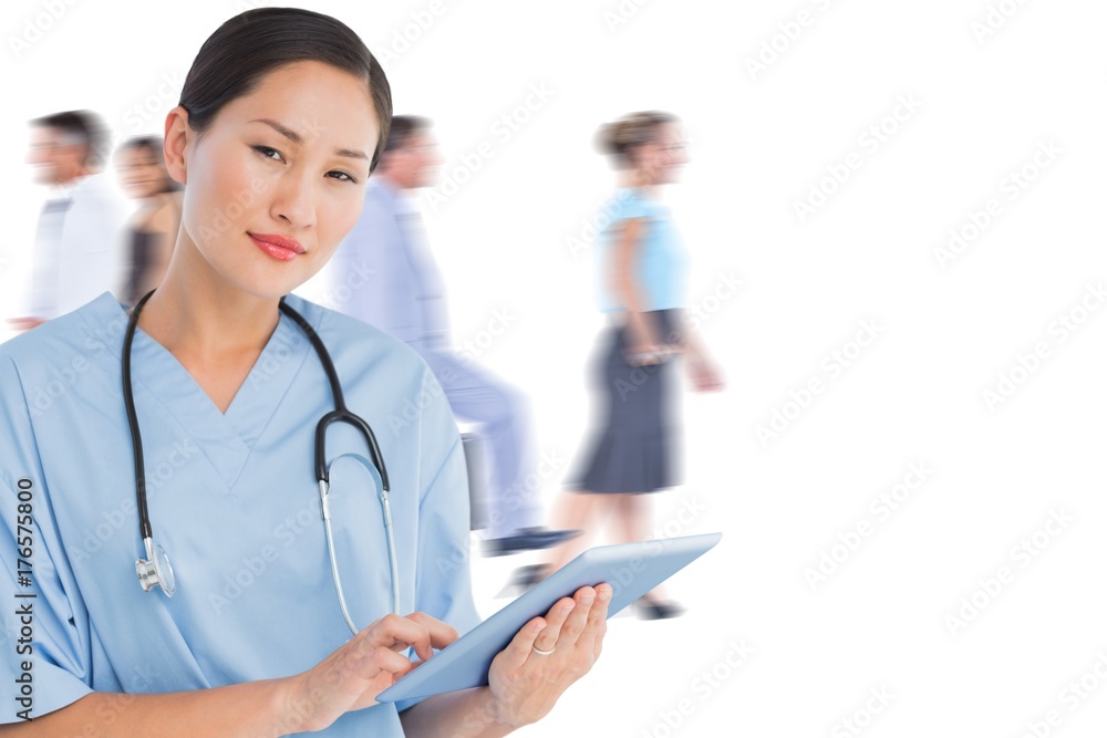 Poster composite image of surgeon using digital tablet with group