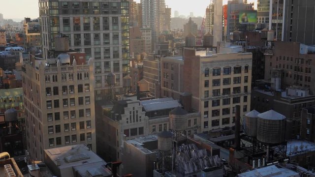 A high angle view of typical midtown Manhattan office and apartment buildings at sunset or morning.  	