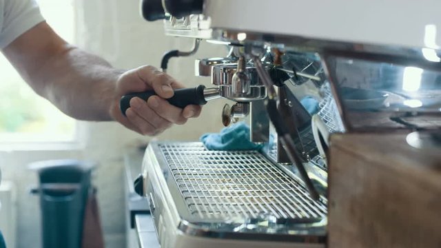  Close up on hands of cafe barista preparing fresh coffee from the machine
