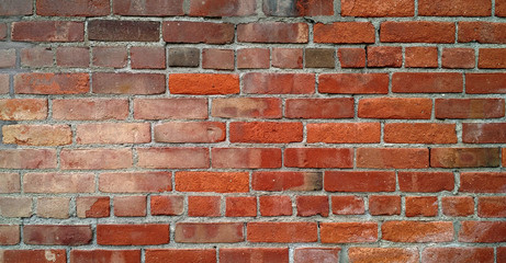 Fototapeta premium Weather-beaten antique brick wall with grungy discolored appearance.