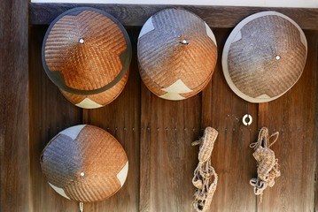 Straw hats and sandals hanging on wall in rural Japan