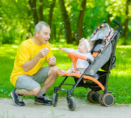 Father and daughter blowing a bubbles in the park