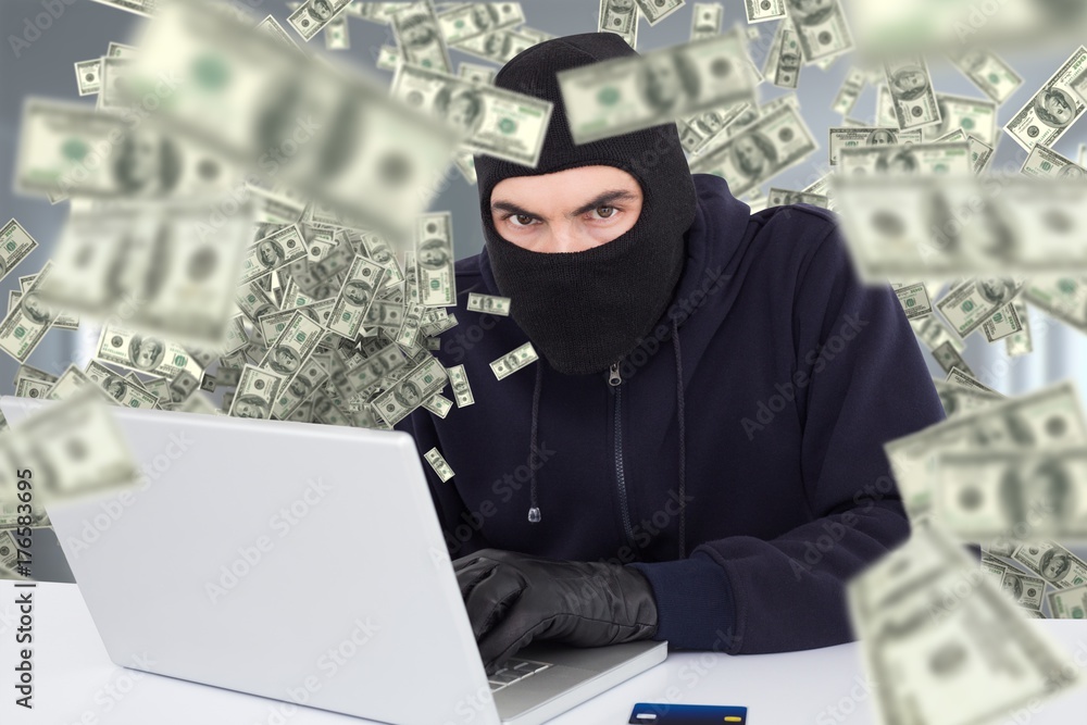 Poster composite image of hacker in balaclava hacking a laptop