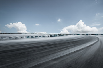 Motion blur asphalt road circuit and sky clouds
