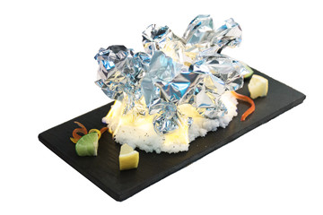 Isolated Burning grilled clams the wrap by foil, burn with salt served with sliced lime on black rectangle plate on washi (Japanese paper). 