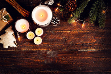 Christmas candle and rustic decoration on wood table with christmas lights in night party. copy...
