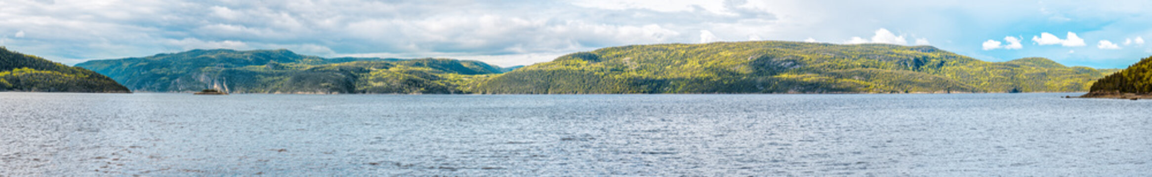 Panorama landscape view of peaceful Fjord Saguenay river in Quebec Canada with mountain cliffs and calm water