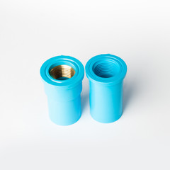 Blue PVC pipe fitting with screw connection on white background