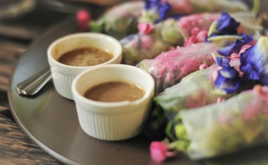 Salad flower roll with sauce.Lettuce, Butterfly pea and Mexican Creeper, Fresh vegetable noodle spring roll.