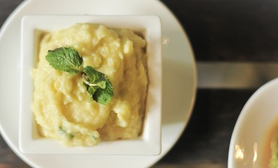 mashed potatoes with melted butter and chives along with gravy on the side 