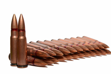 Long cartridges with a sharp copper-colored tip on a background