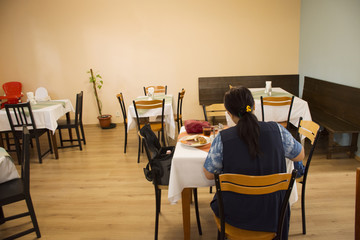 Asian travelers thai woman eating breakfast in restaurant room of resort