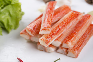 Red crab stick with green lettuce and coriander, pepper and other spices.