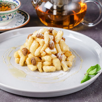 Tatar dessert chak-chak with almonds .