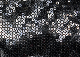 Abstract background with  black sequins on the fabric. 