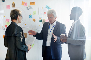 Confident mature investigator explaining his version of crime