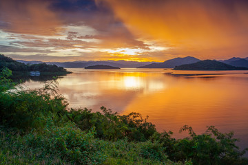 Fototapeta na wymiar Sunset light, Hill, lake and reflection over the Dam, Keang Krachan Dam, Petchaburee, Thailand.