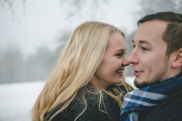 Glückliches Paar in Winterlandschaft mit Wintermantel